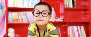 Young boy with round glasses at preschool